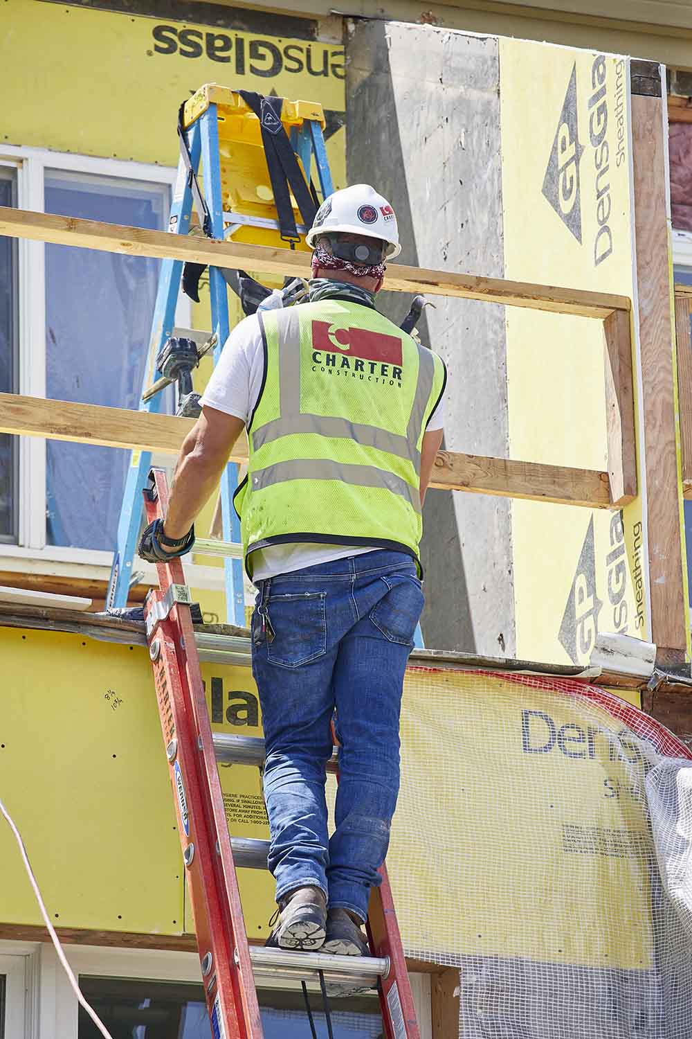 columbia-point-exterior-repairs-man-ladder Columbia Point exterior repairs man on a ladder